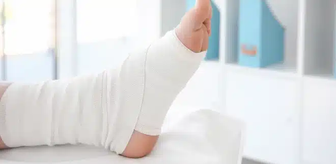A patient's foot and ankle wrapped in an elastic bandage to help ensure proper healing. Wrapping your foot in the correct position after an injury is important. Seek medical attention if you are having difficulty moving your foot or suspect a possible break.