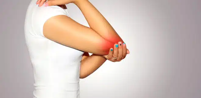A woman experiencing elbow discomfort.