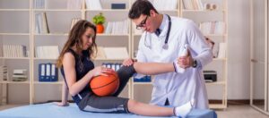 Blogs 1 Doctor examining basketball player’s knee injury.
